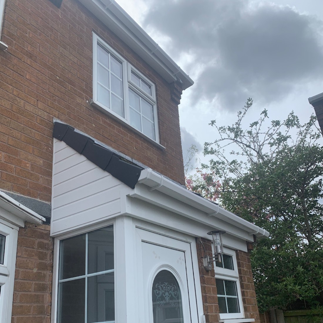 White uPVC fascia, soffit and guttering on a brick semi