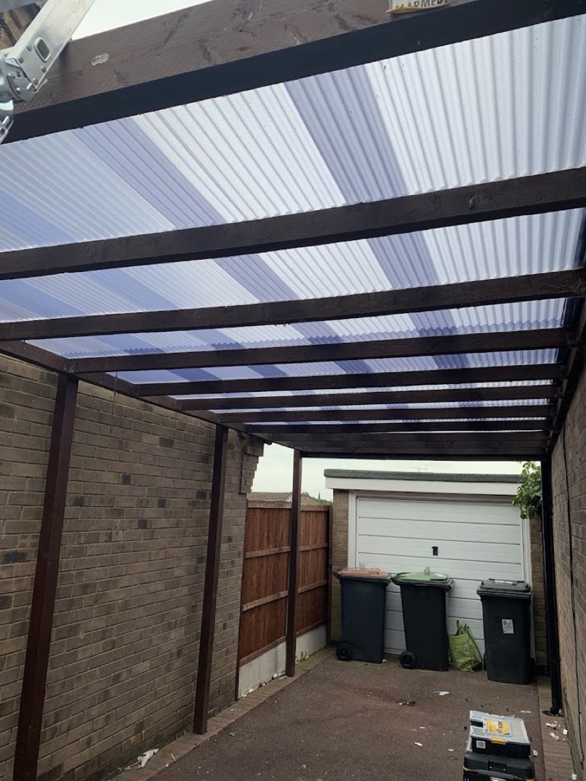 Polycarbonate lean-to carport roof on timber frame