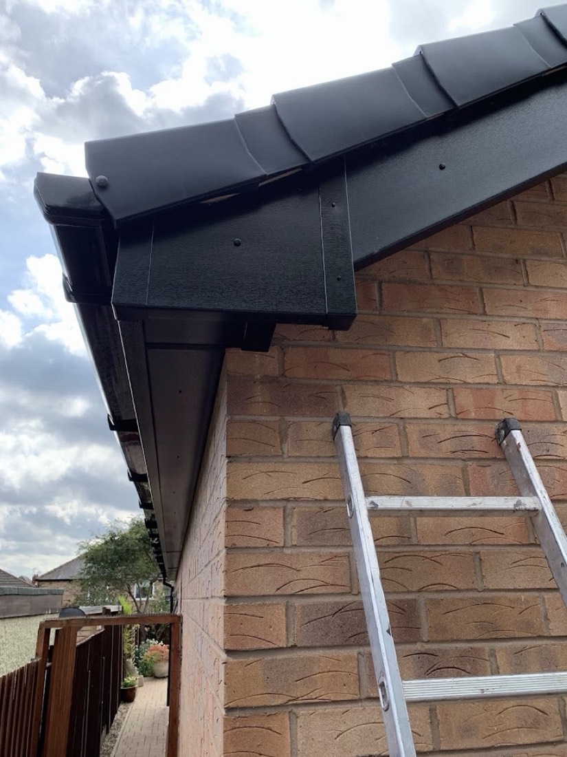 New black fascia, soffit and bargeboard on a brick house